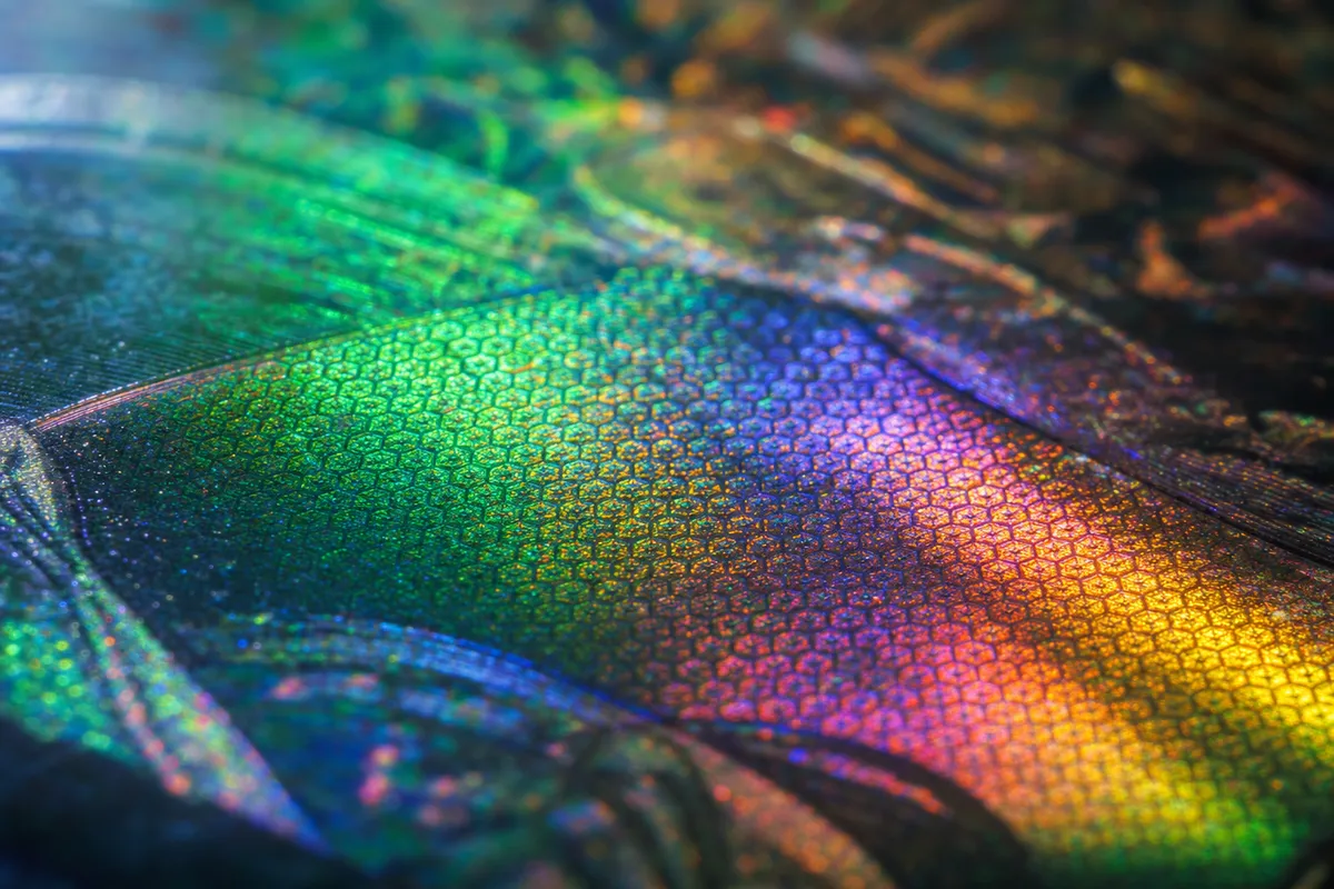 Macro of iridescent rainbow foil texture on a trading card surface